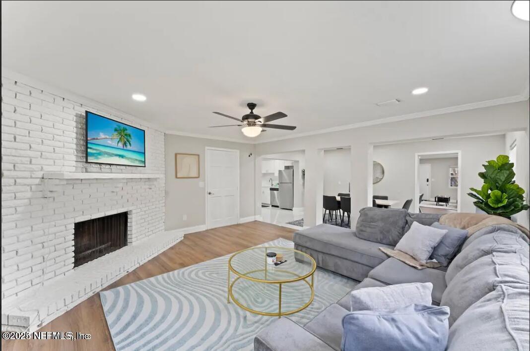 1247 Rensselaer Avenue Jacksonville, FL 32205 - Photo 14 of 24 a living room with furniture a fireplace and a chandelier
