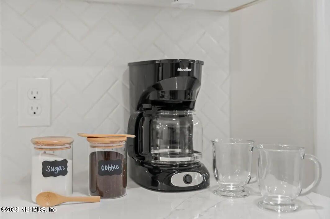 1247 Rensselaer Avenue Jacksonville, FL 32205 - Photo 19 of 24 a kitchen with a stove and white cabinets