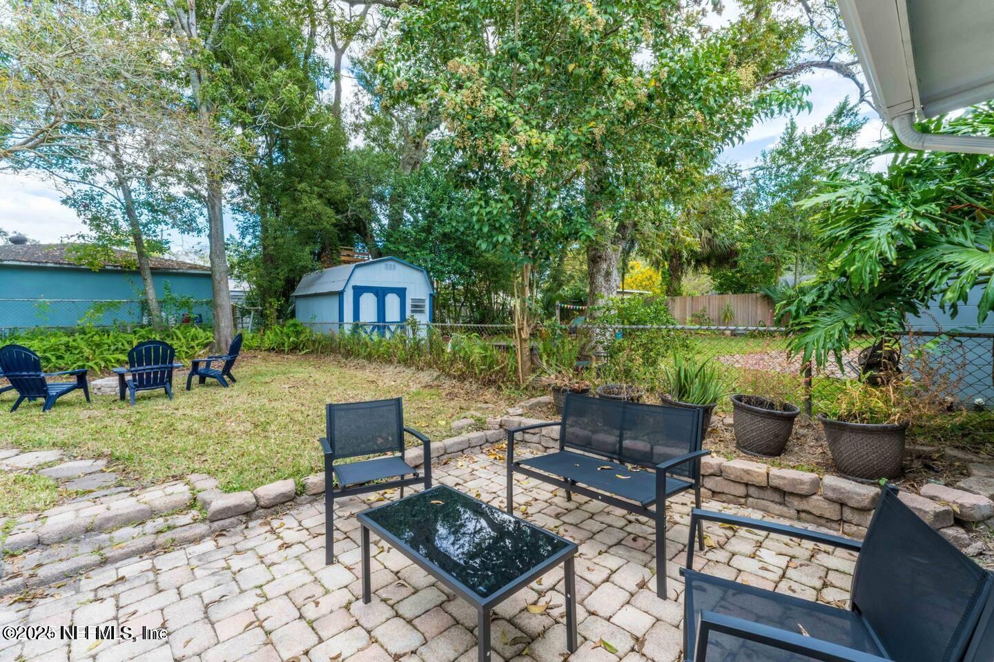 1247 Rensselaer Avenue Jacksonville, FL 32205 - Photo 22 of 24 a view of a patio with couches table and chairs and potted plants