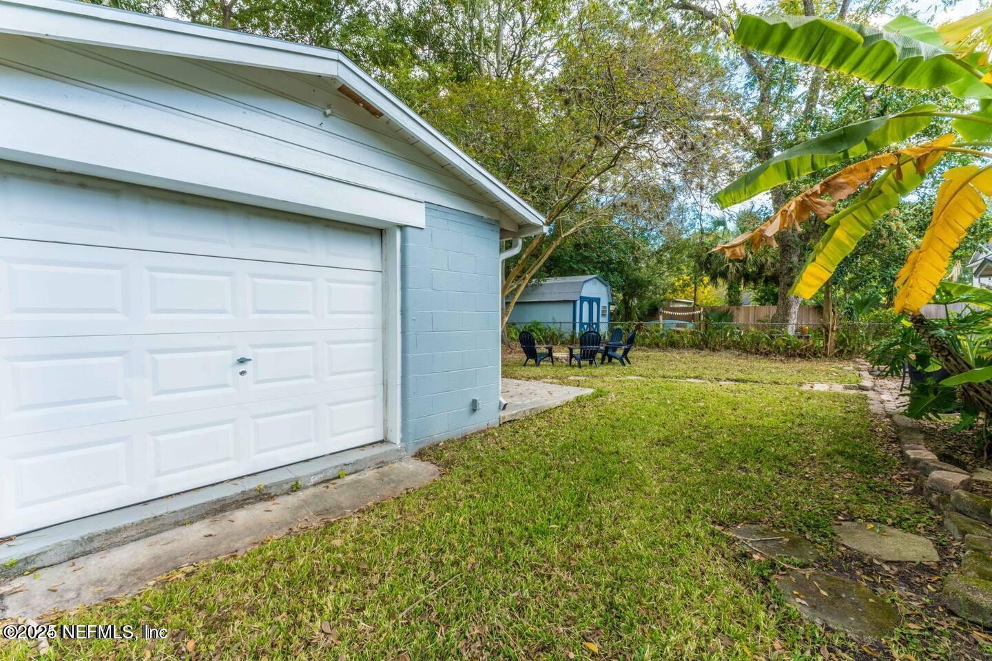 1247 Rensselaer Avenue Jacksonville, FL 32205 - Photo 24 of 24 a view of backyard with large trees and flower plants