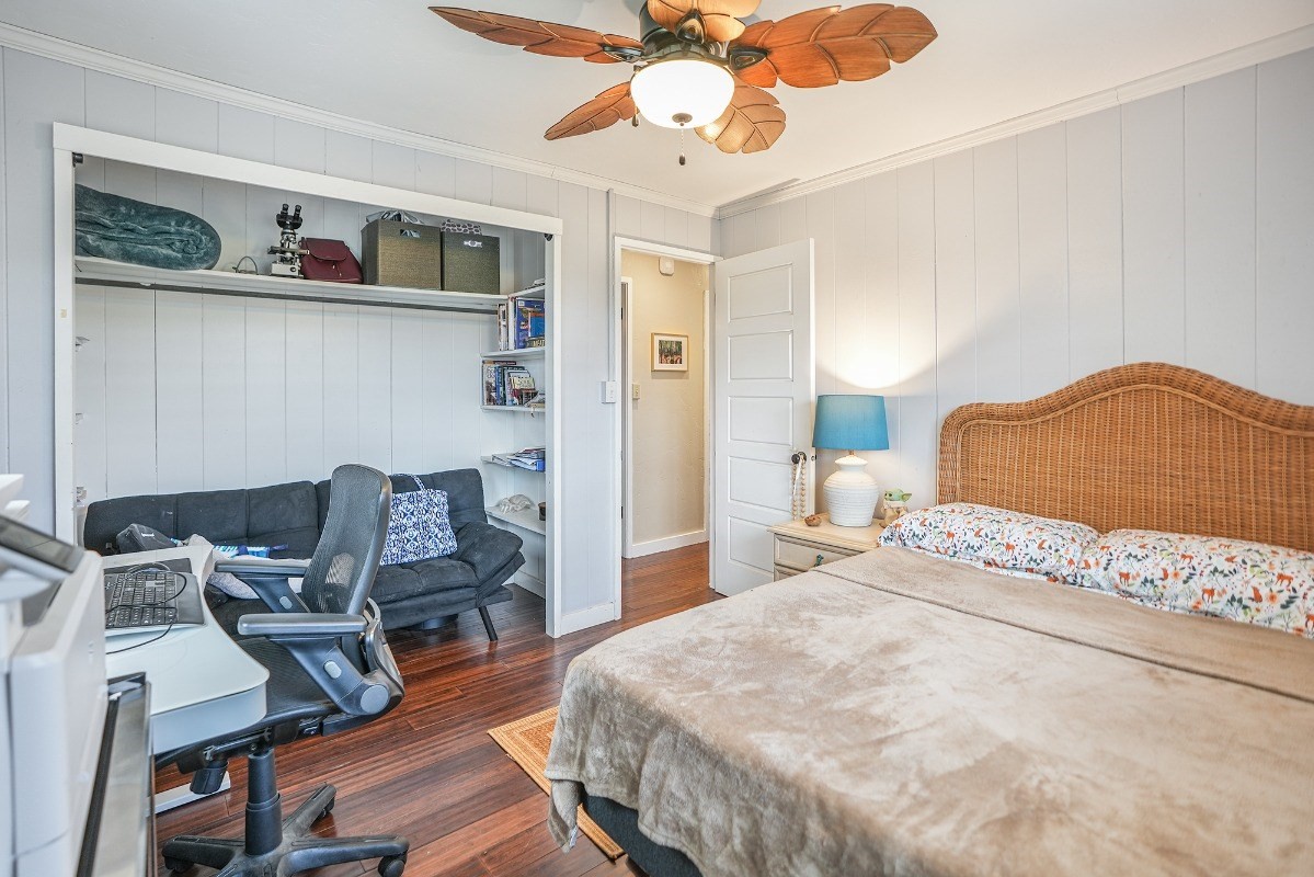 8778 Kekaha Road Kekaha, HI 96752 - Photo 12 of 18 a bedroom with a bed and wooden floor