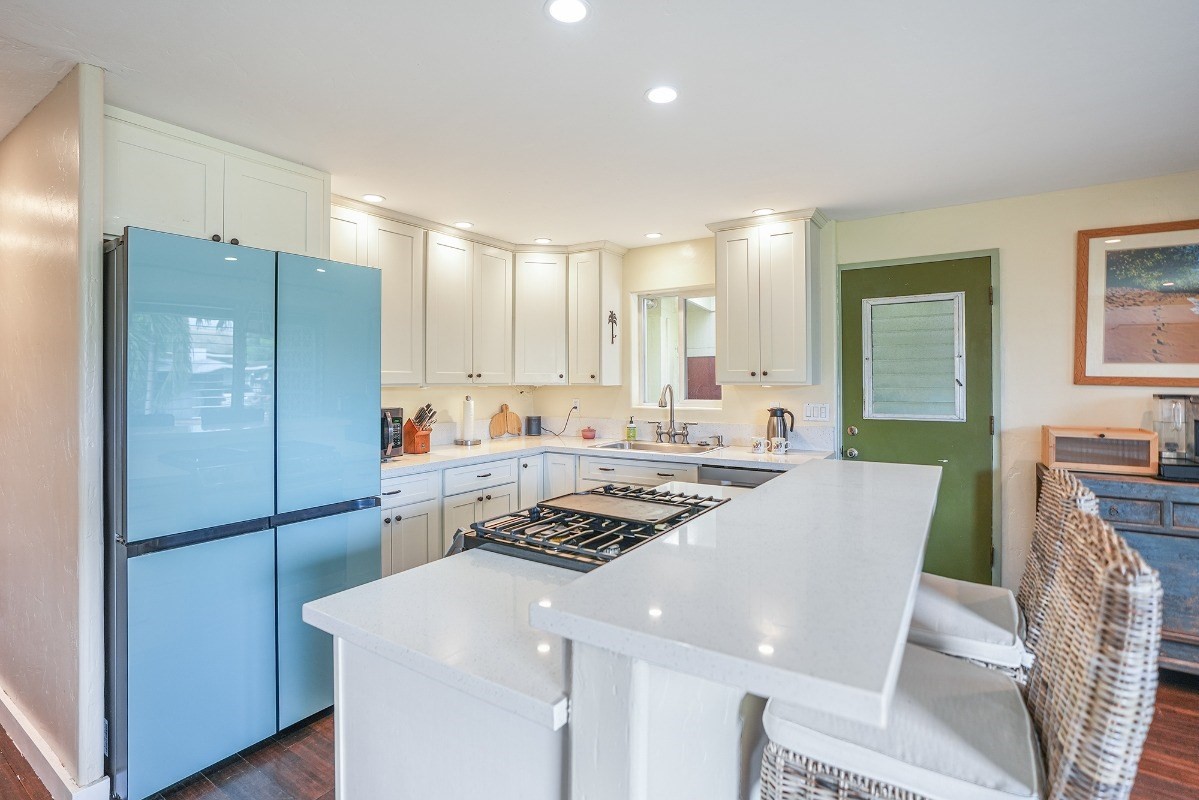8778 Kekaha Road Kekaha, HI 96752 - Photo 3 of 18 a kitchen with a refrigerator a stove top oven a sink and cabinets