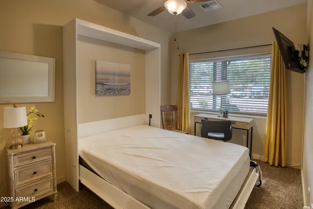 a bedroom with a bed and a window