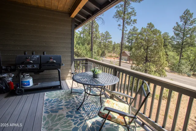a view of a deck with wooden floor and outdoor seating