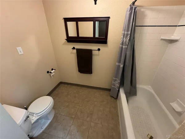 a bathroom with a tub a sink and a shower