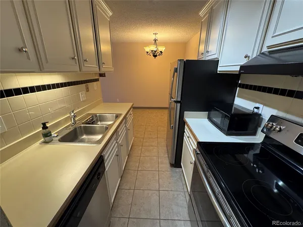 a kitchen with a sink appliances and cabinets