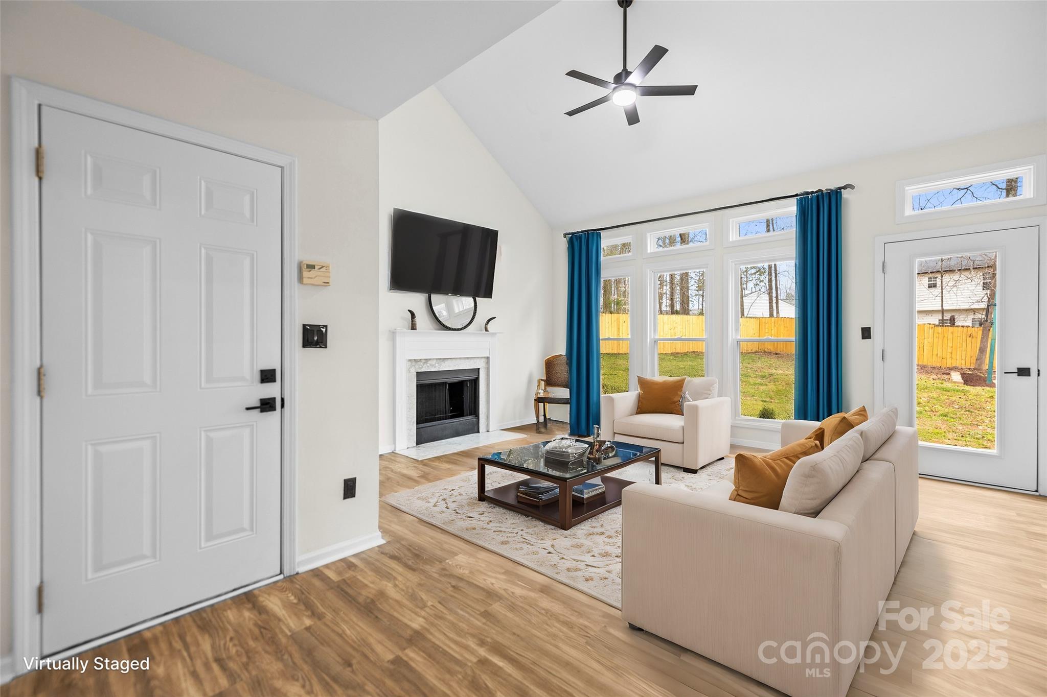 10211 Ridgewell Court Charlotte, NC 28215 - Photo 1 of 41 a living room with furniture a fireplace and a flat screen tv