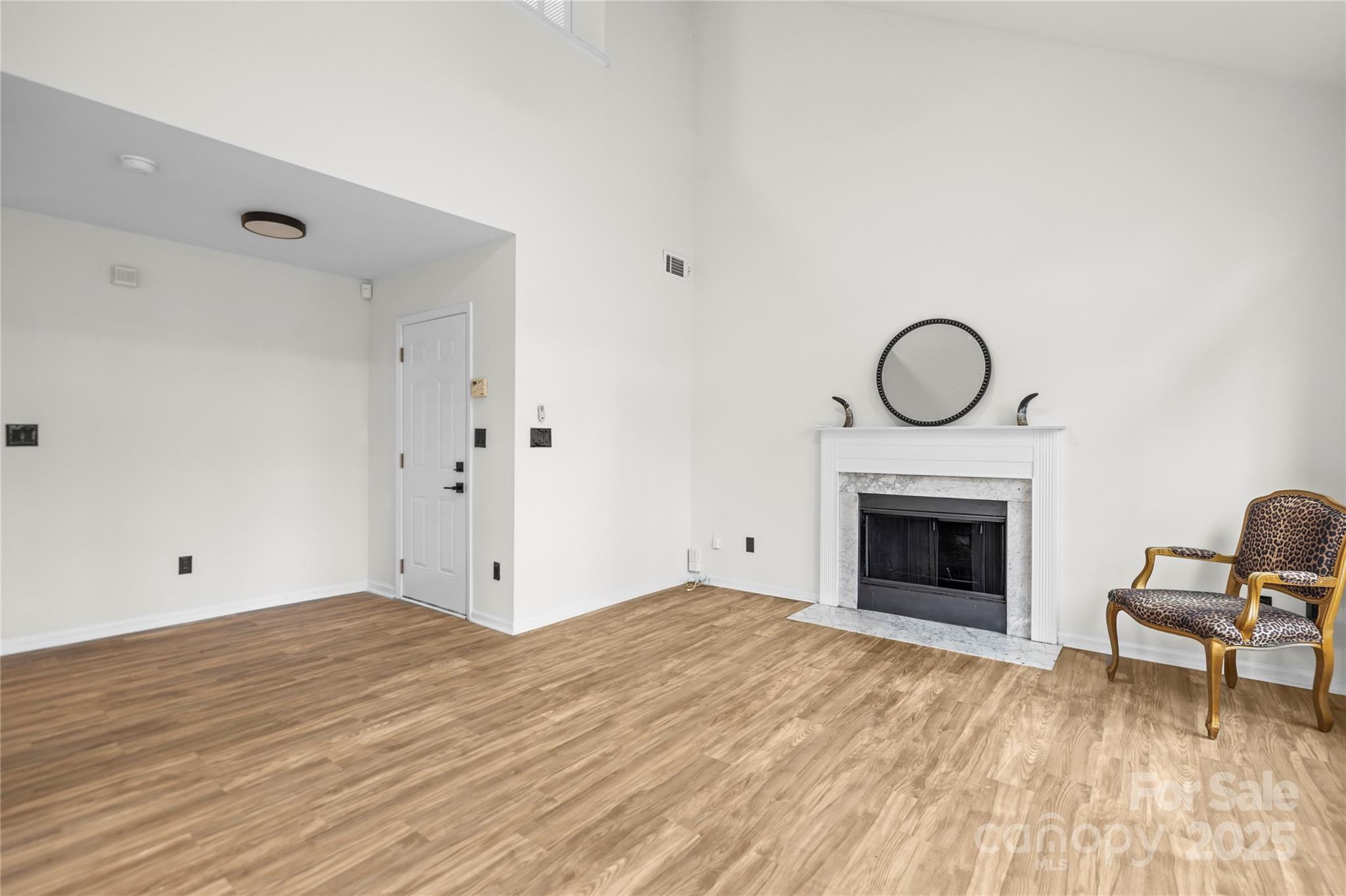 10211 Ridgewell Court Charlotte, NC 28215 - Photo 12 of 41 a view of empty room with wooden floor and fireplace