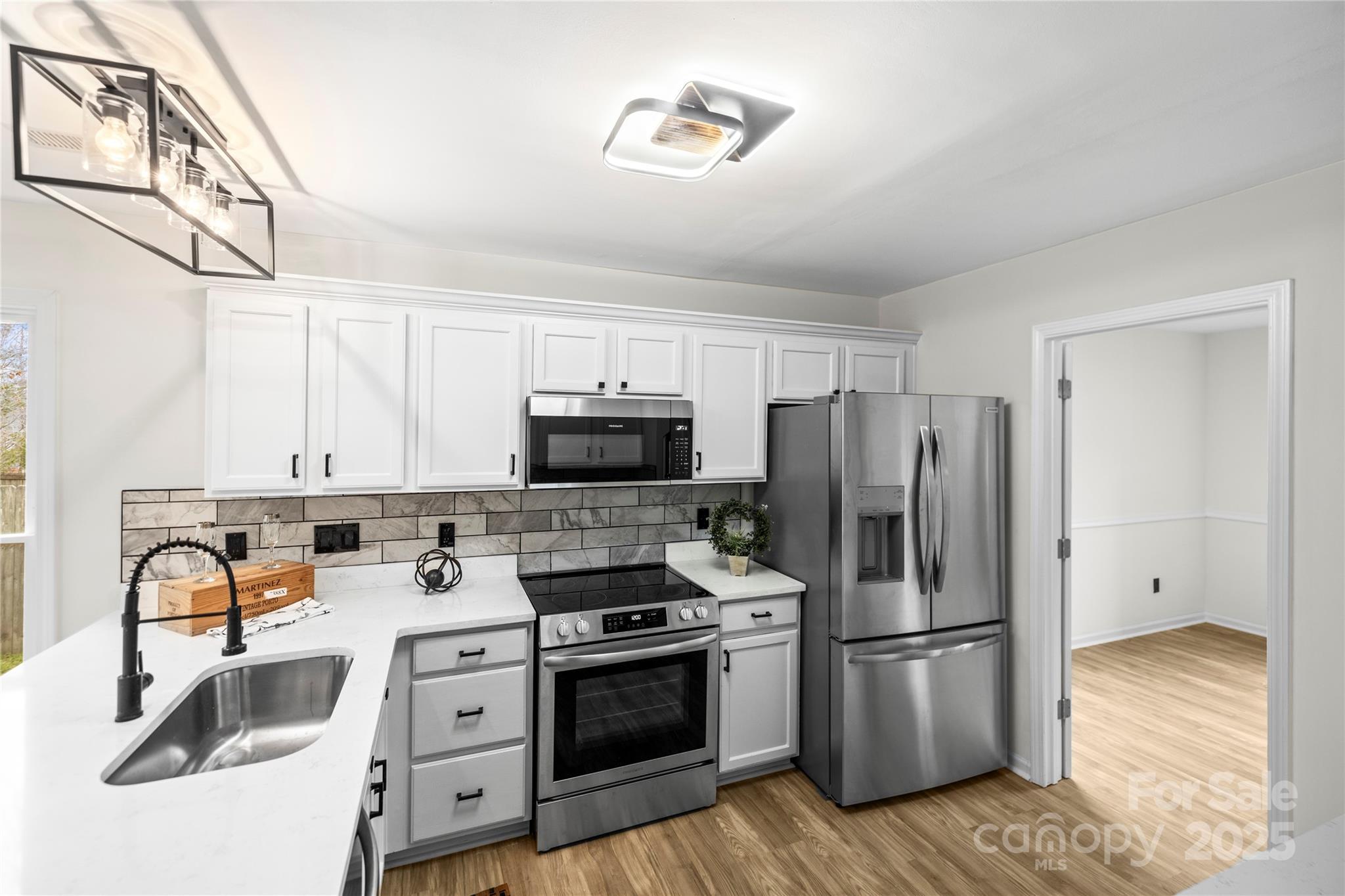 10211 Ridgewell Court Charlotte, NC 28215 - Photo 14 of 41 a kitchen with stainless steel appliances a refrigerator stove and sink