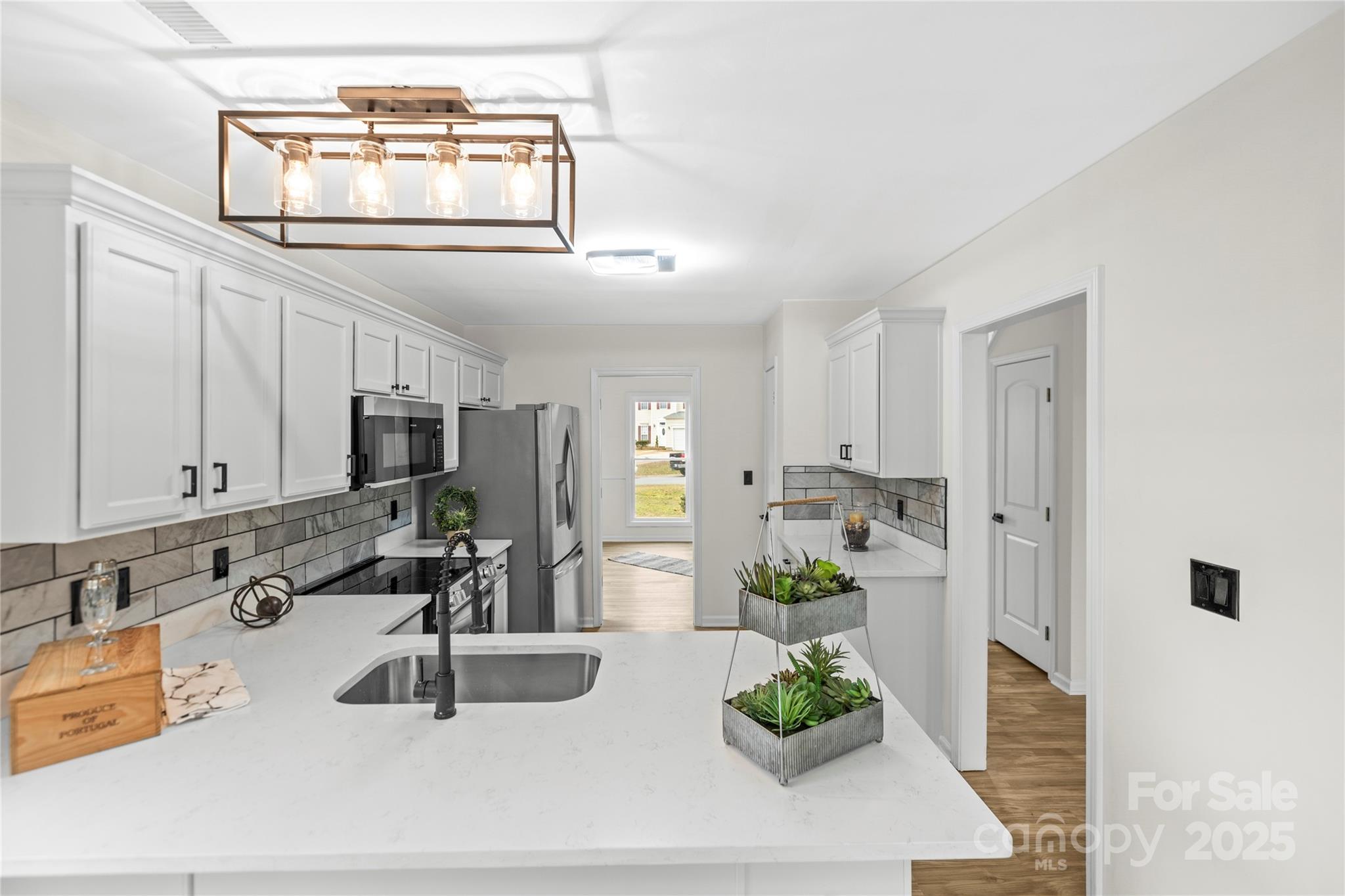 10211 Ridgewell Court Charlotte, NC 28215 - Photo 16 of 41 a kitchen with stainless steel appliances a sink a window and cabinets