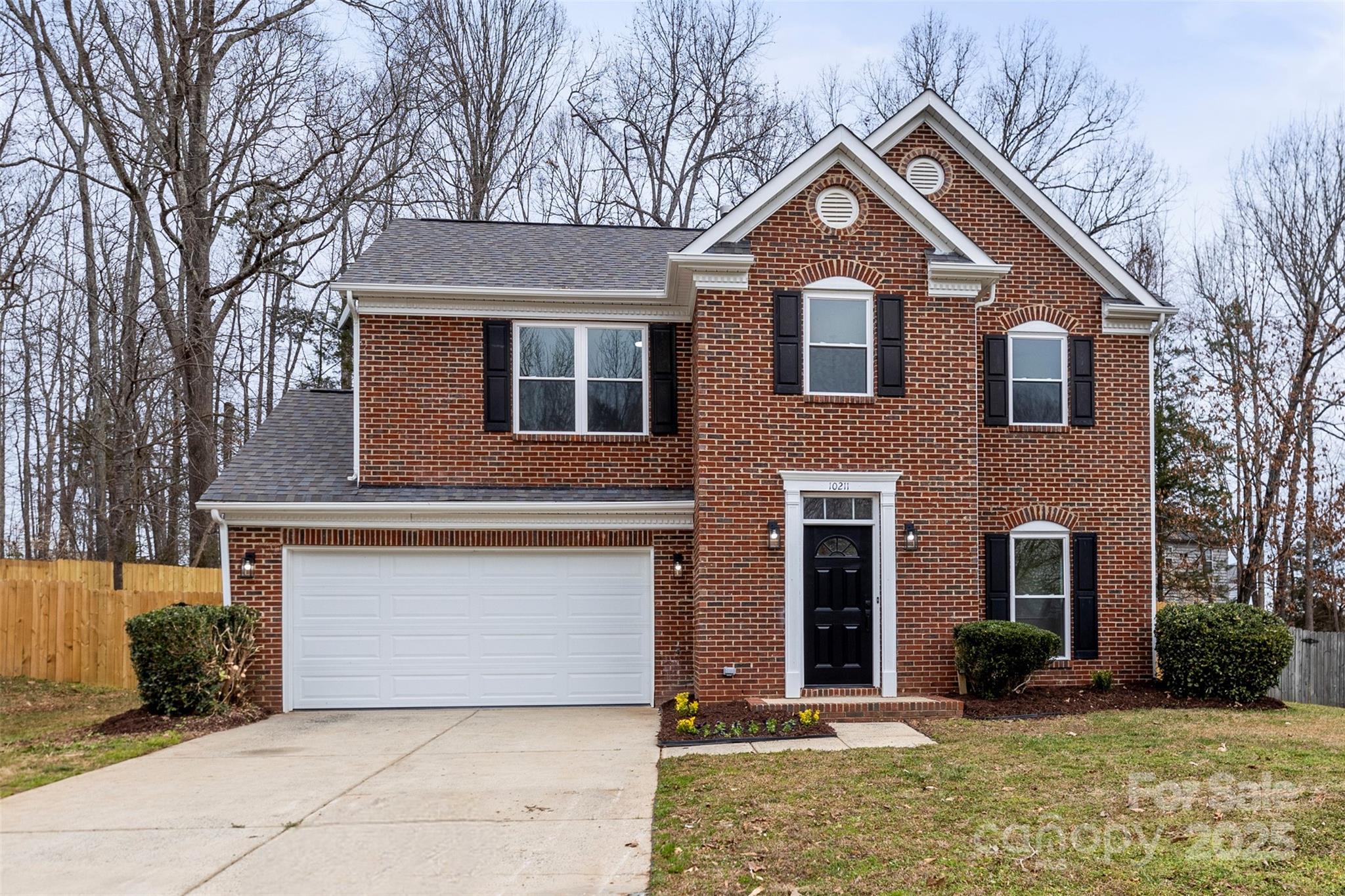 10211 Ridgewell Court Charlotte, NC 28215 - Photo 2 of 41 a front view of a house with a yard