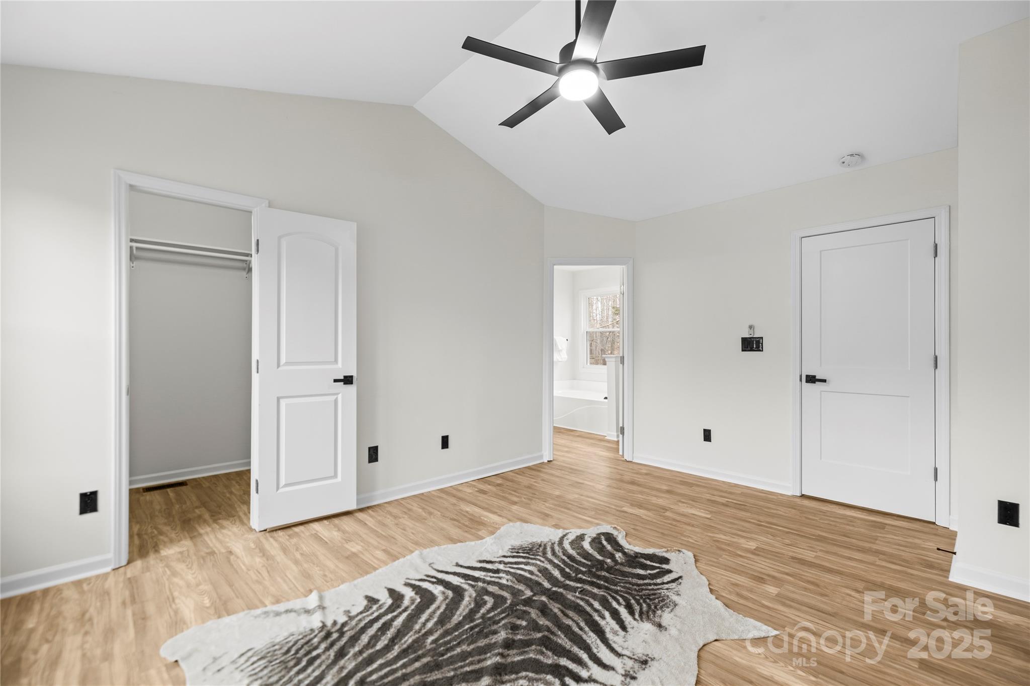 10211 Ridgewell Court Charlotte, NC 28215 - Photo 21 of 41 a view of a bedroom with a bed and wooden floor