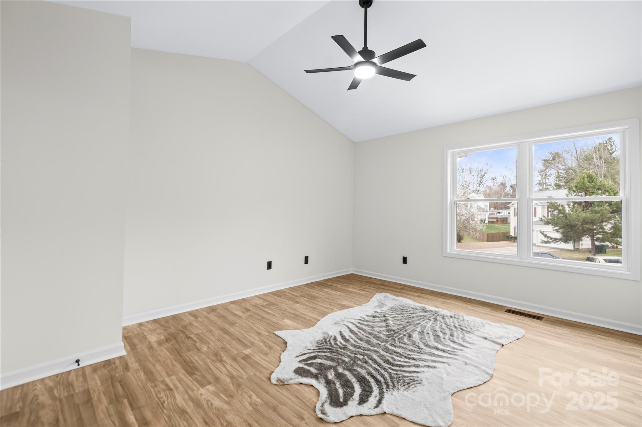 10211 Ridgewell Court Charlotte, NC 28215 - Photo 22 of 41 a view of a bedroom with a large bed and a window