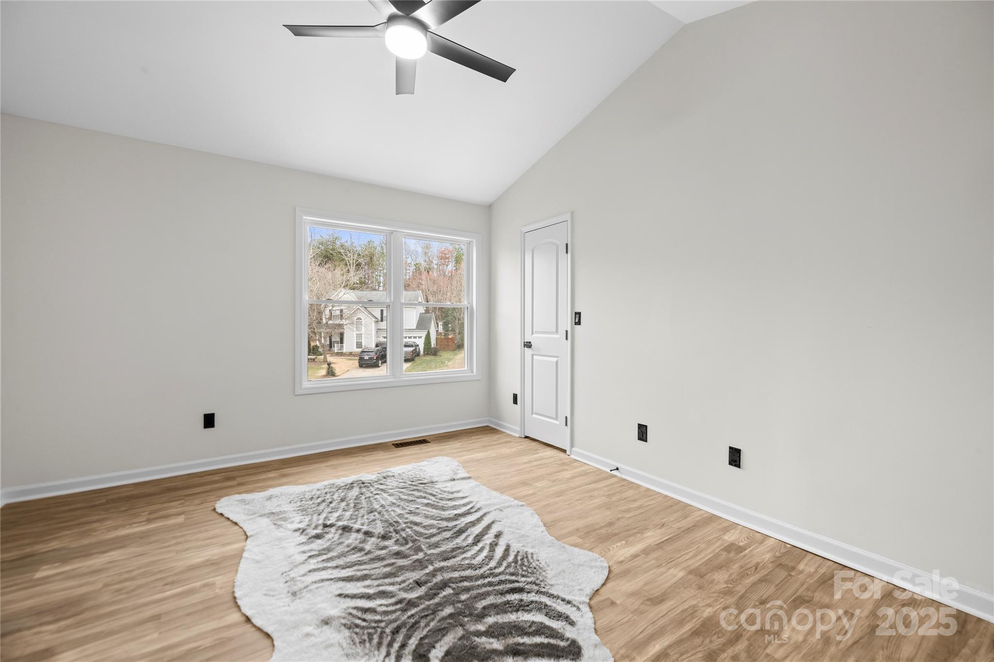 10211 Ridgewell Court Charlotte, NC 28215 - Photo 23 of 41 a view of a bedroom with wooden floor and window