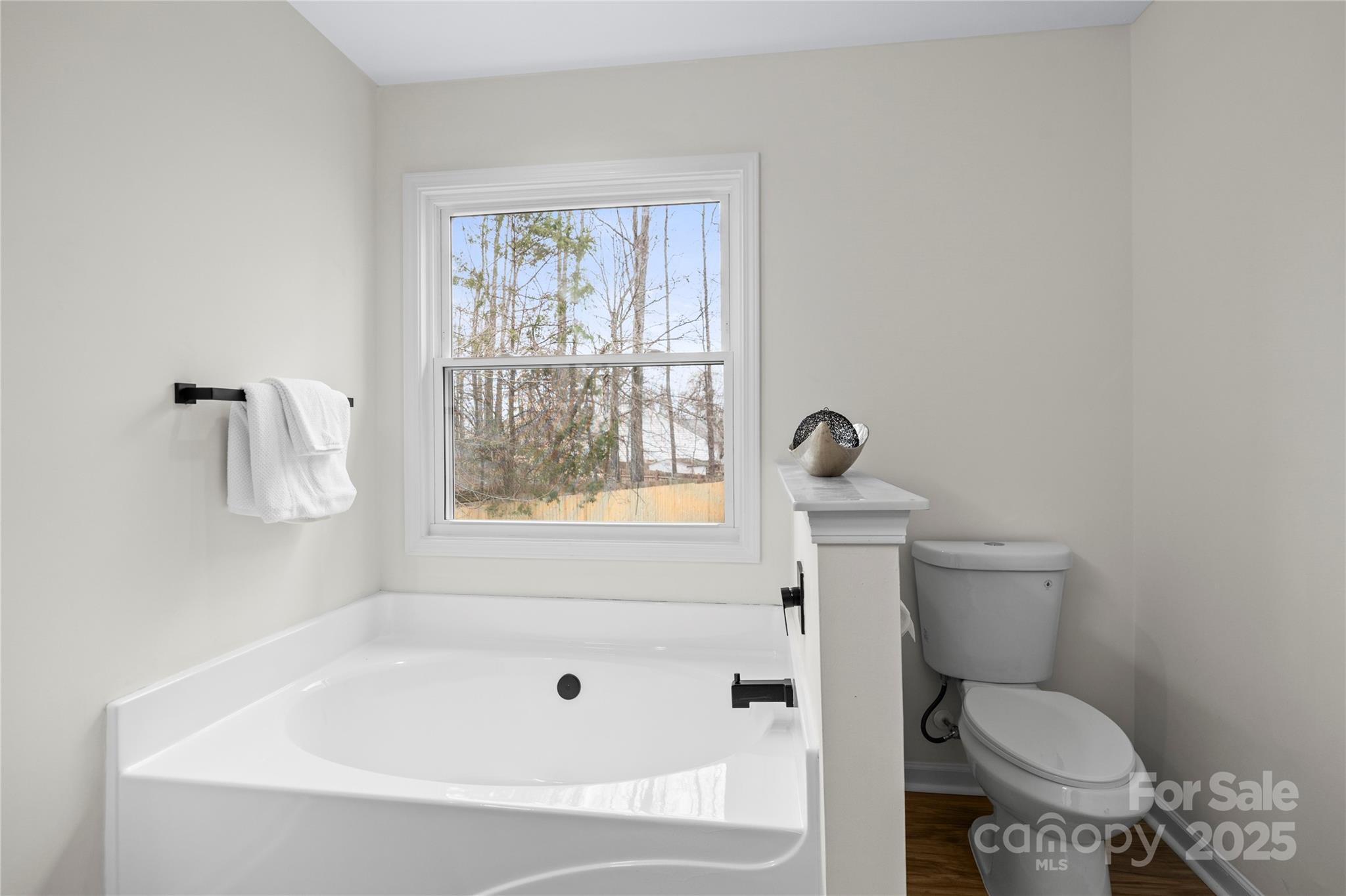 10211 Ridgewell Court Charlotte, NC 28215 - Photo 26 of 41 a white toilet sitting next to a bath tub