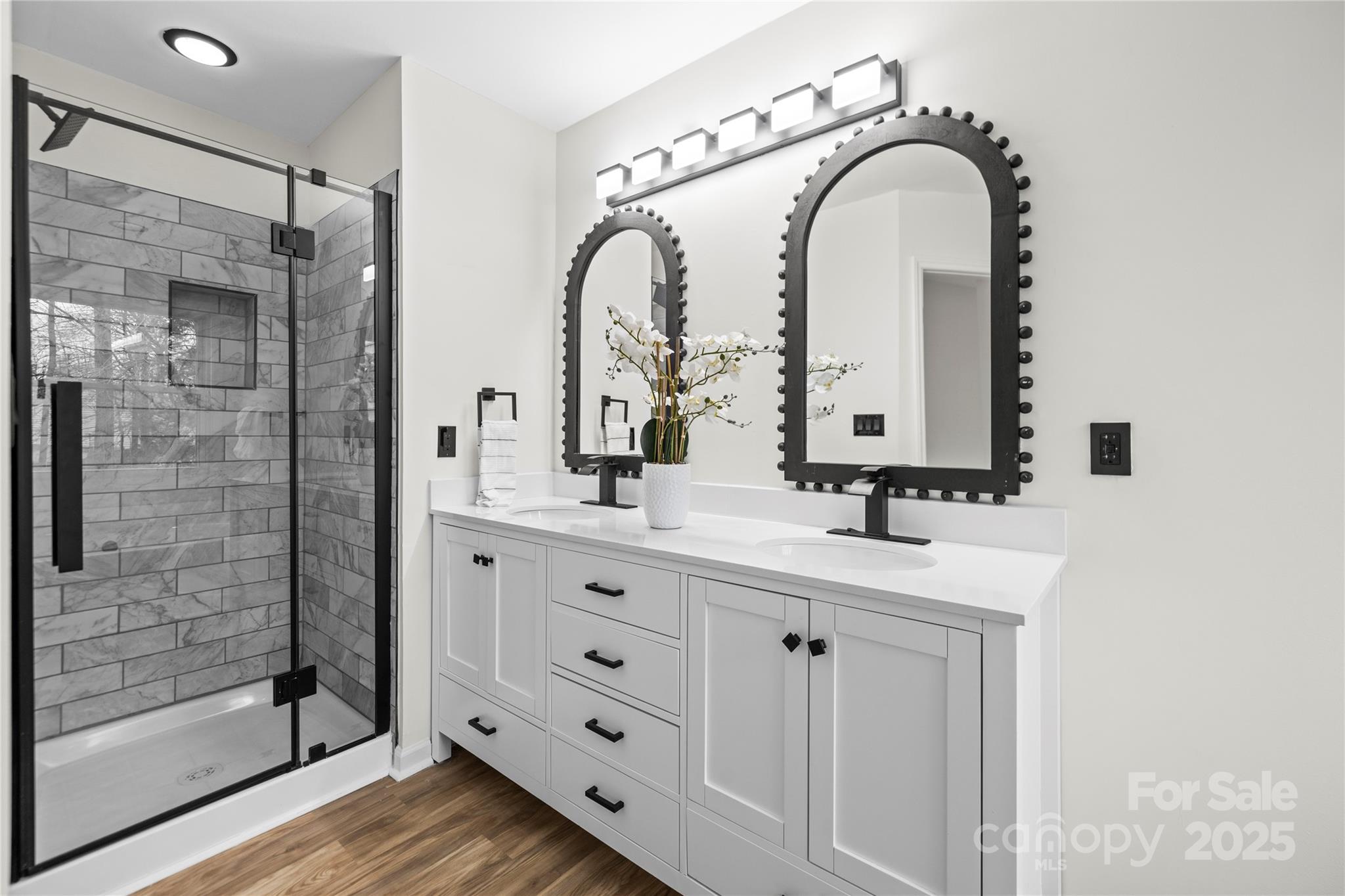 10211 Ridgewell Court Charlotte, NC 28215 - Photo 27 of 41 a bathroom with a double vanity sink mirror and shower