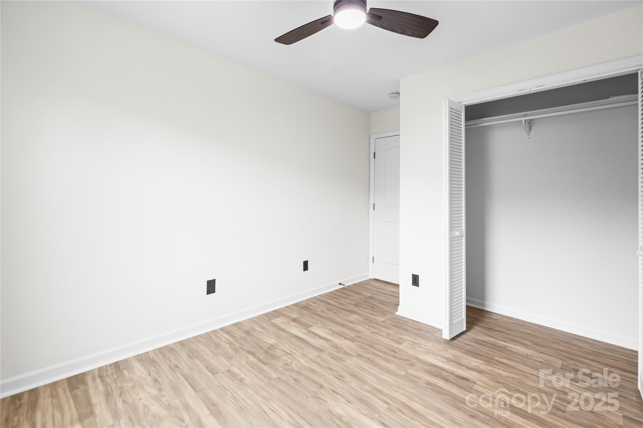 10211 Ridgewell Court Charlotte, NC 28215 - Photo 28 of 41 an empty room with wooden floor and windows
