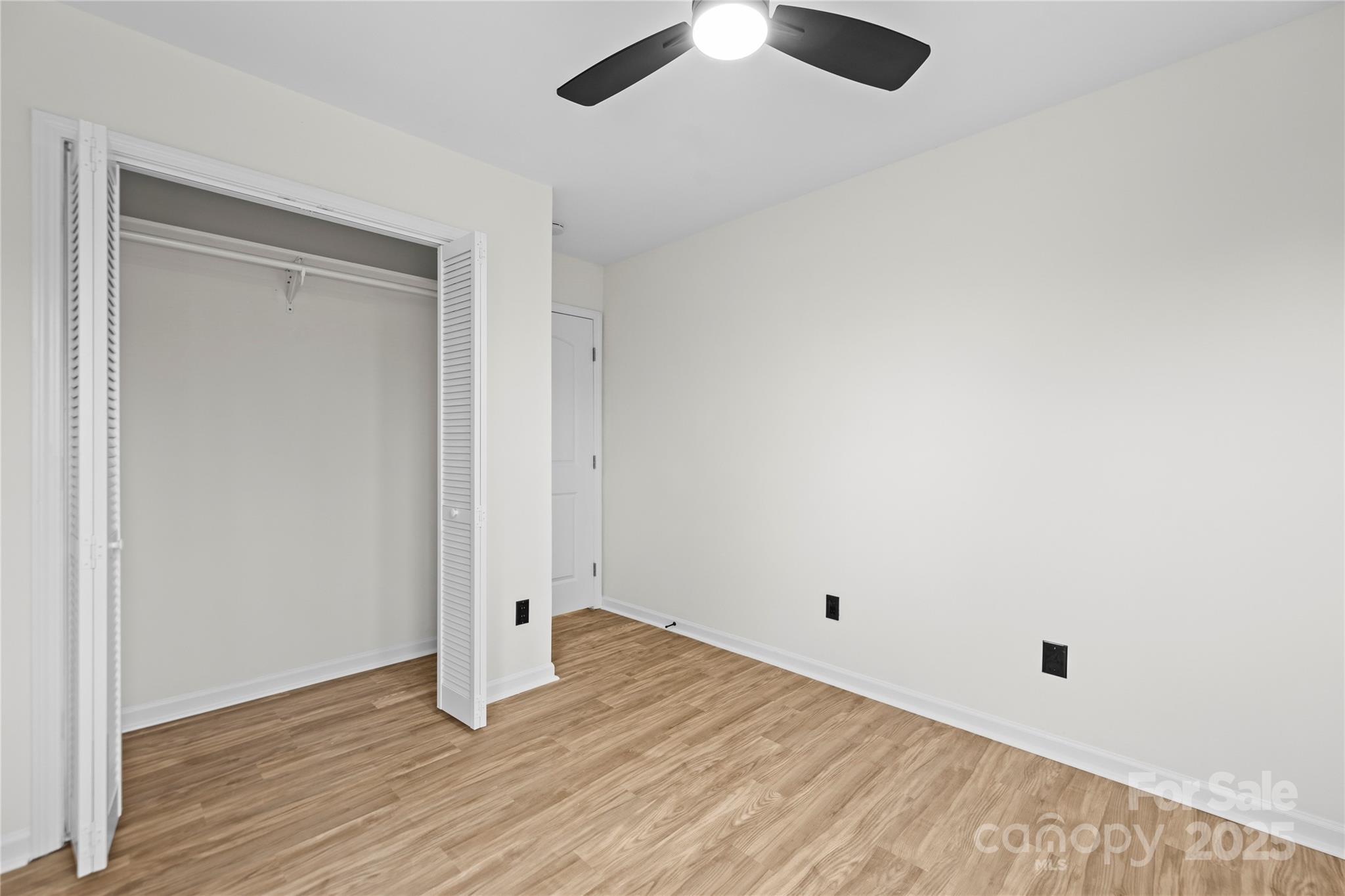 10211 Ridgewell Court Charlotte, NC 28215 - Photo 31 of 41 an empty room with wooden floor and windows