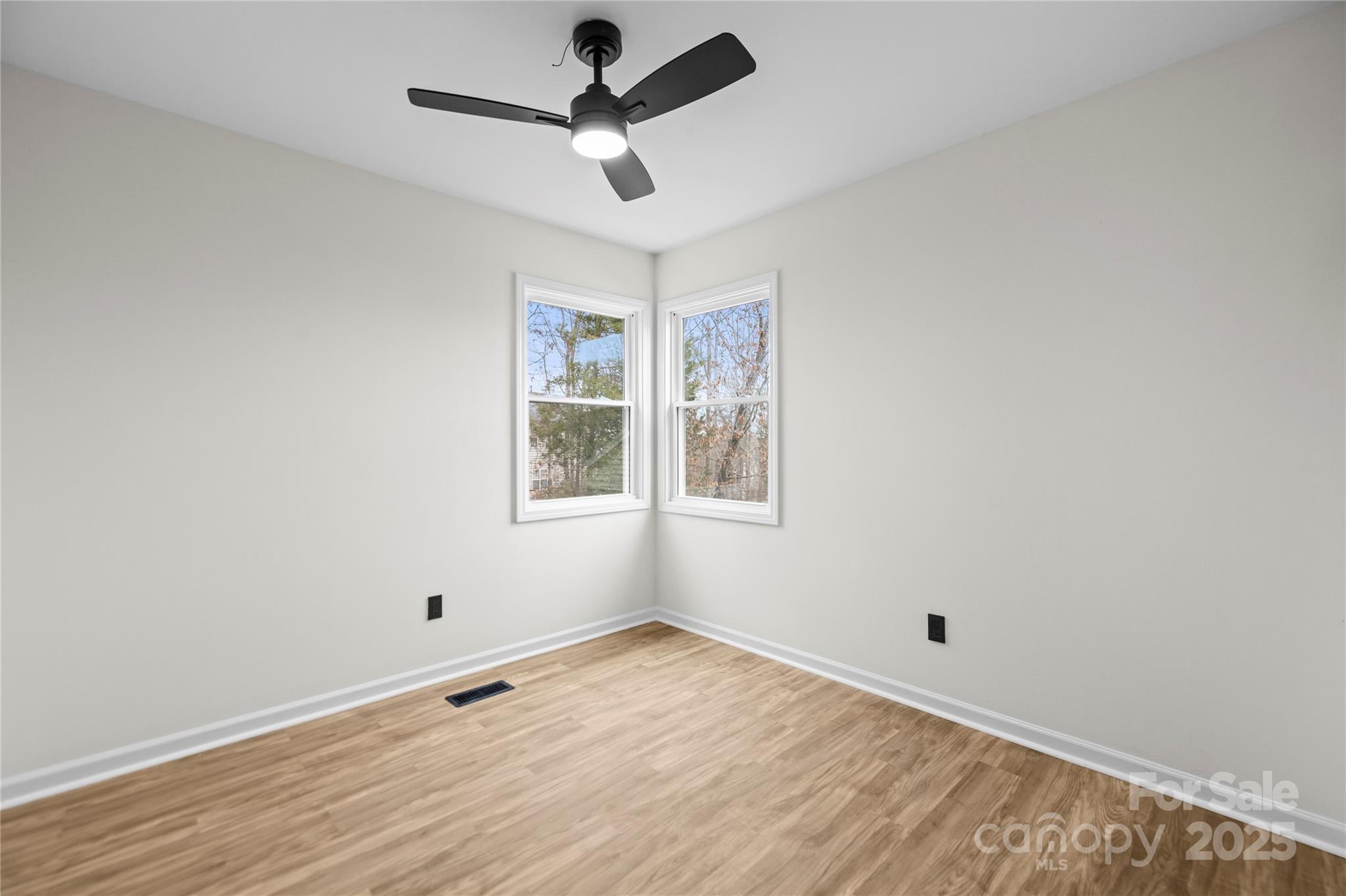 10211 Ridgewell Court Charlotte, NC 28215 - Photo 32 of 41 wooden floor in an empty room with a window