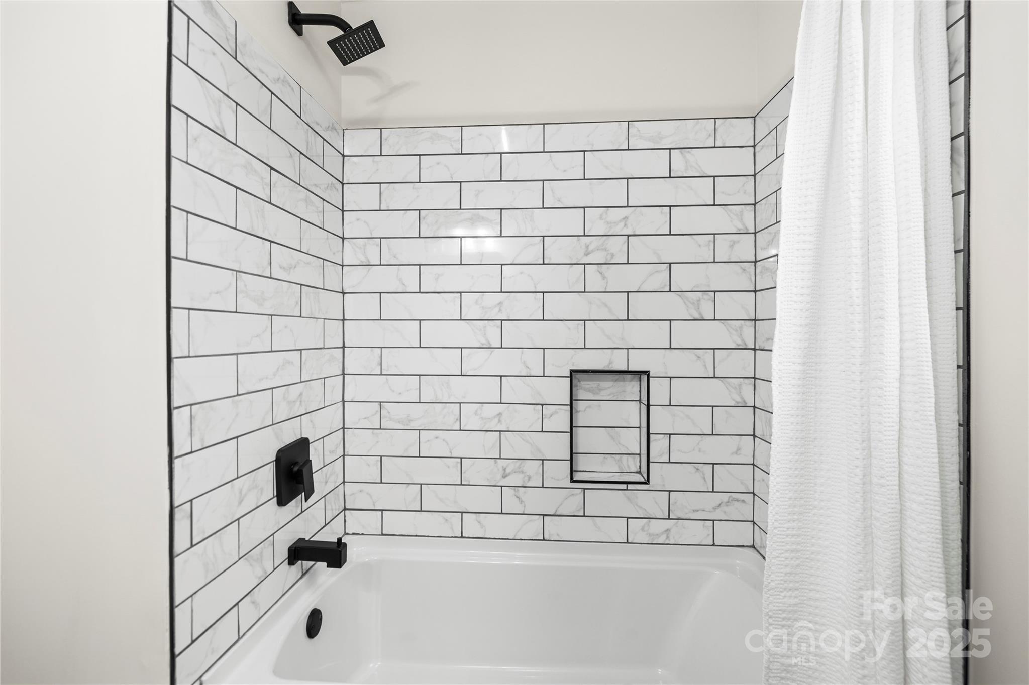 10211 Ridgewell Court Charlotte, NC 28215 - Photo 33 of 41 a bathroom with a bathtub