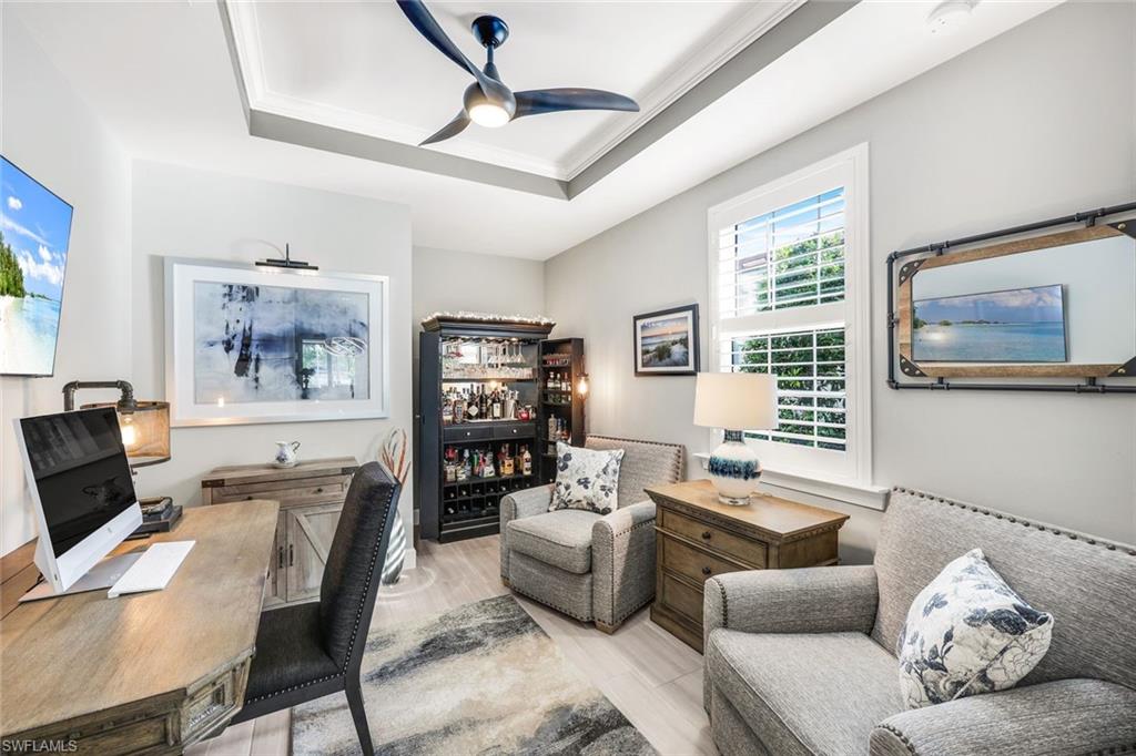 20022 Parrot Key Court Estero, FL 33928 - Photo 11 of 31 a living room with furniture and a flat screen tv