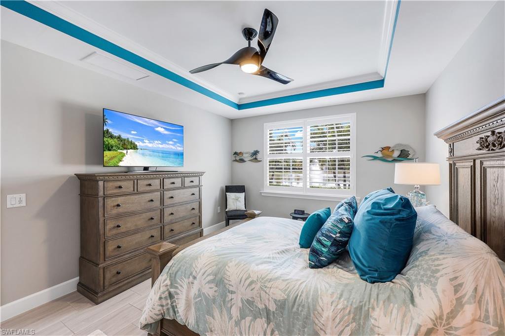 20022 Parrot Key Court Estero, FL 33928 - Photo 13 of 31 a bedroom with a bed a dresser and a window
