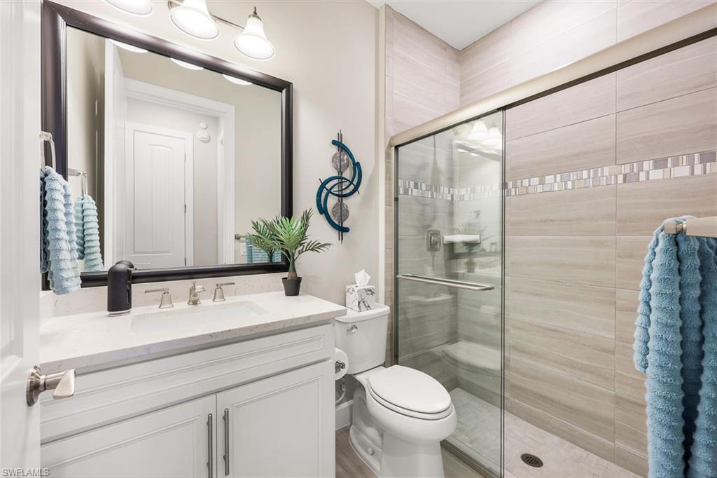 20022 Parrot Key Court Estero, FL 33928 - Photo 14 of 31 a bathroom with a sink a toilet and shower