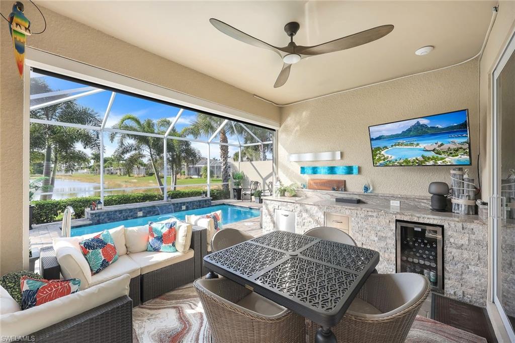 20022 Parrot Key Court Estero, FL 33928 - Photo 16 of 31 a living room with furniture and a floor to ceiling window