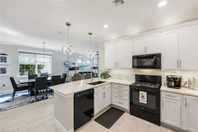 a kitchen with a sink stove and microwave