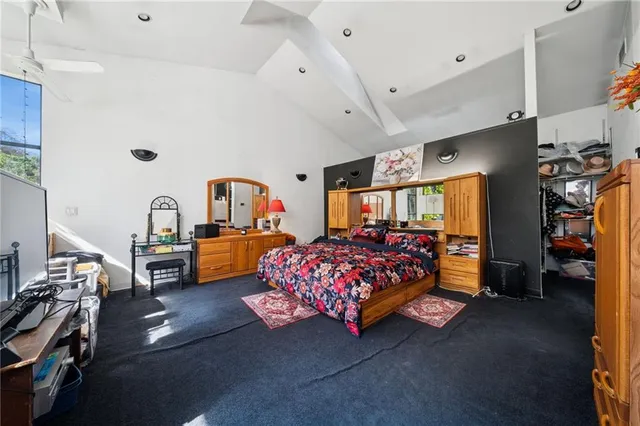 a bedroom with furniture and a flat screen tv