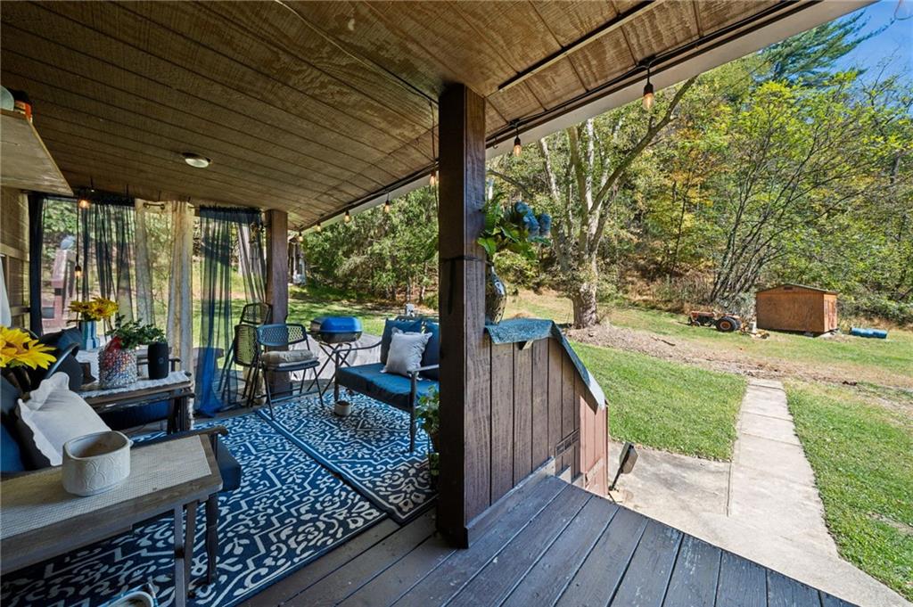 824 Magnus Lane Irwin, PA 15642 - Photo 27 of 40 a balcony with chairs and wooden floor