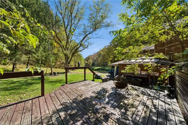 a view of a house with backyard porch and sitting area