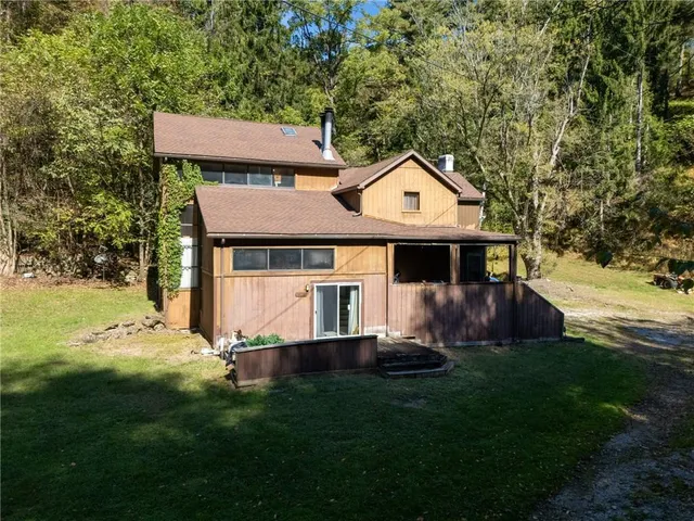 a front view of a house with a garden and yard