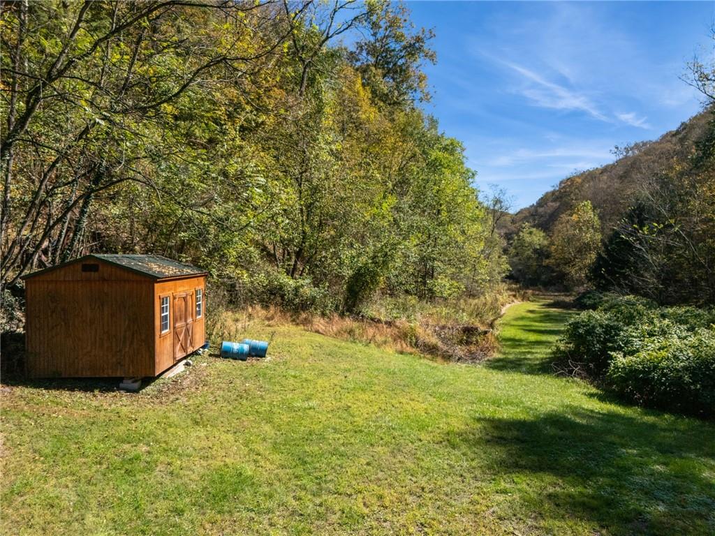 824 Magnus Lane Irwin, PA 15642 - Photo 36 of 40 a backyard of a house with lots of green space