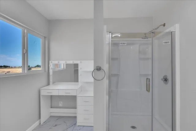 a bathroom with a shower and a sink