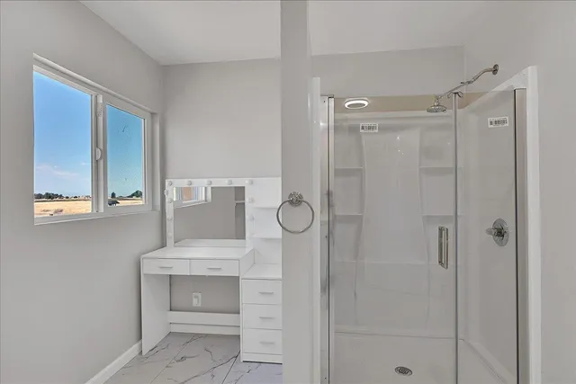 a bathroom with a toilet a sink a mirror and a shower