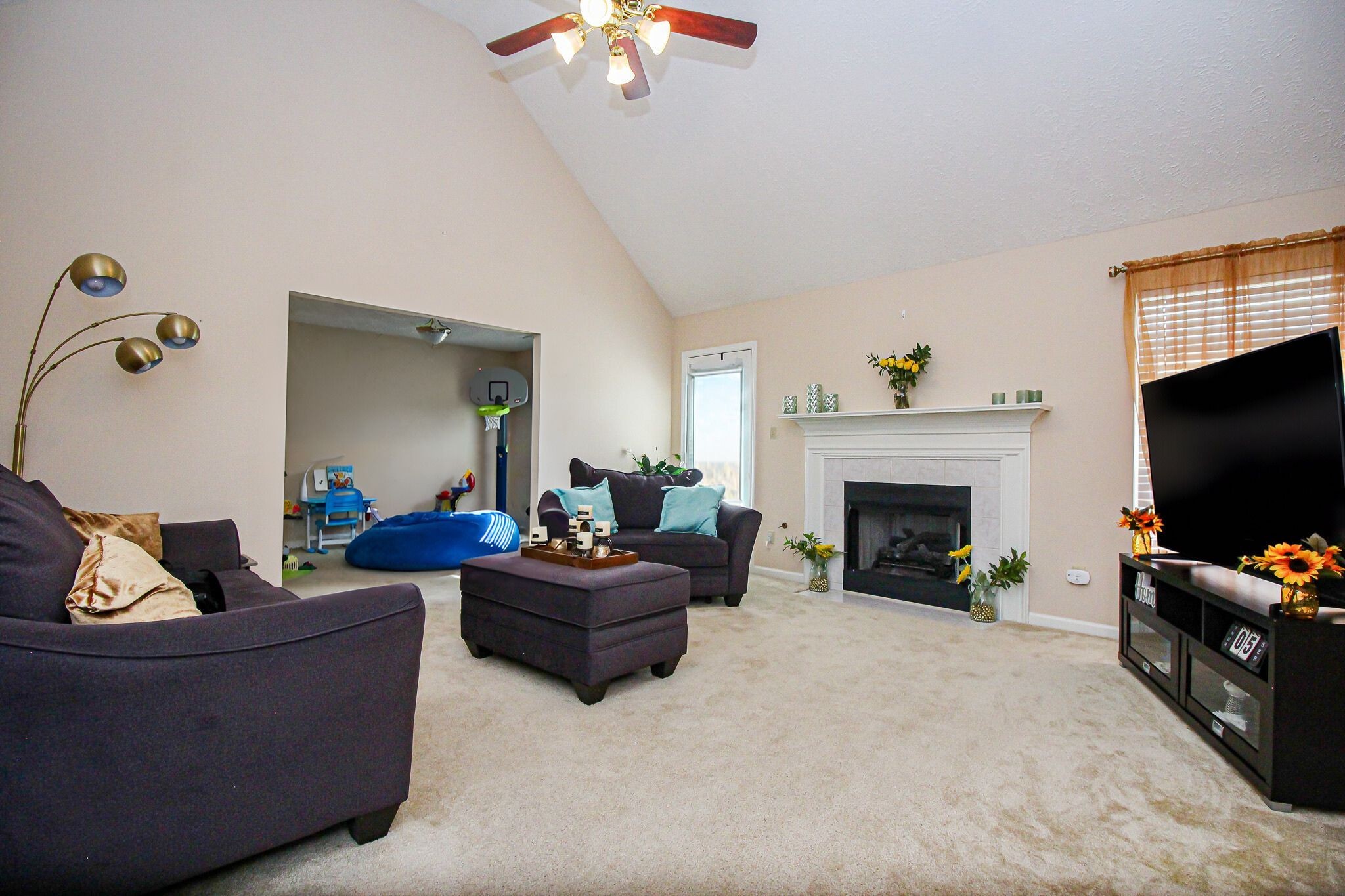 9 Battlefield Cove Jackson, TN 38305 - Photo 12 of 24 a living room with furniture a fireplace and a flat screen tv