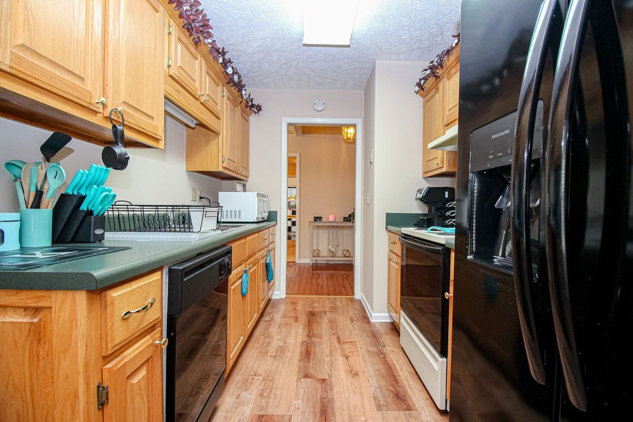 9 Battlefield Cove Jackson, TN 38305 - Photo 14 of 24 a kitchen with stainless steel appliances granite countertop a refrigerator a stove and a sink