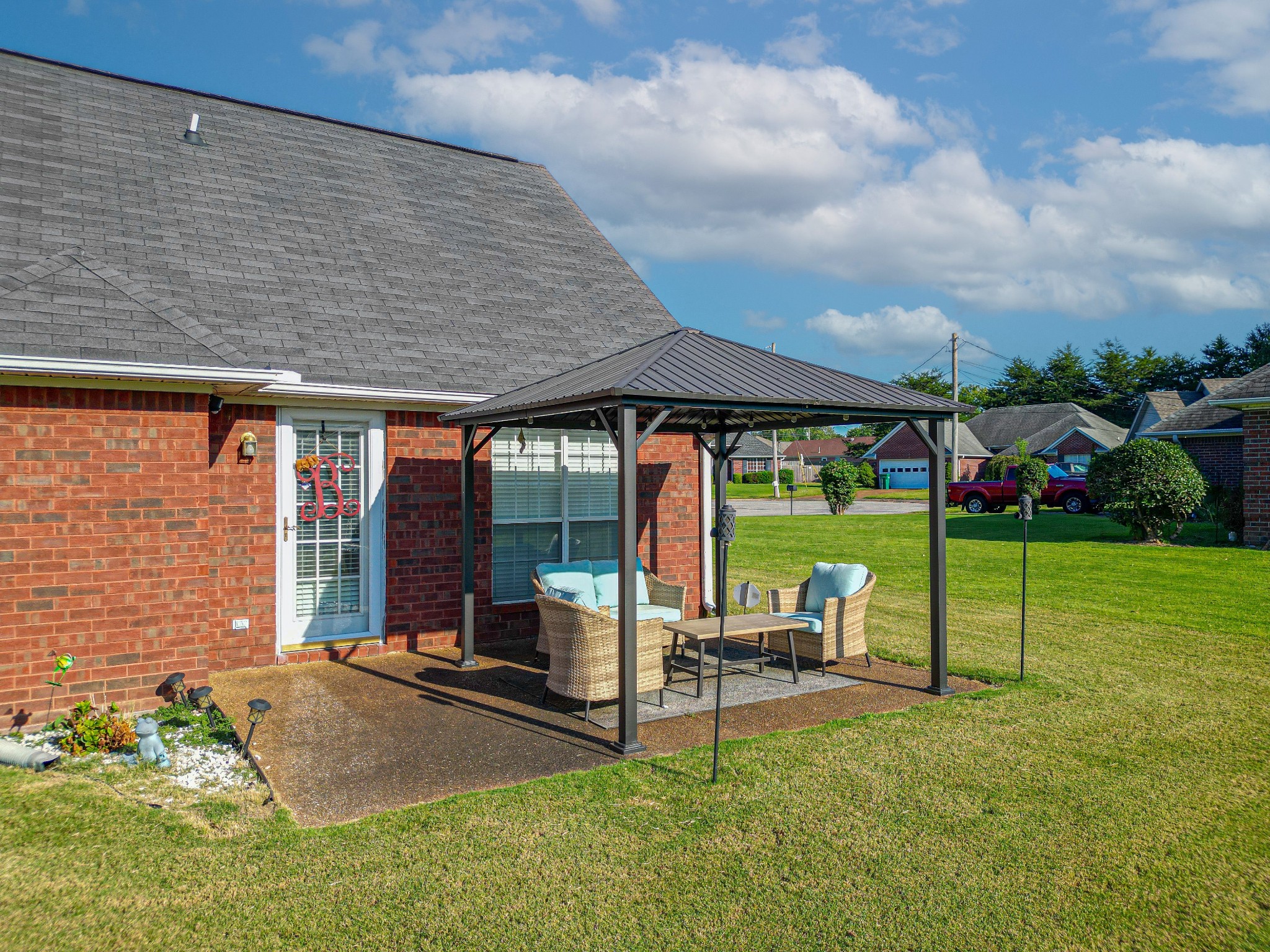 9 Battlefield Cove Jackson, TN 38305 - Photo 20 of 24 a view of a house with backyard sitting area and garden
