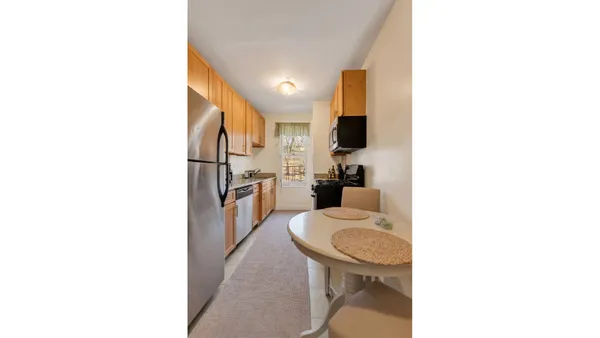 a kitchen with a refrigerator and a stove