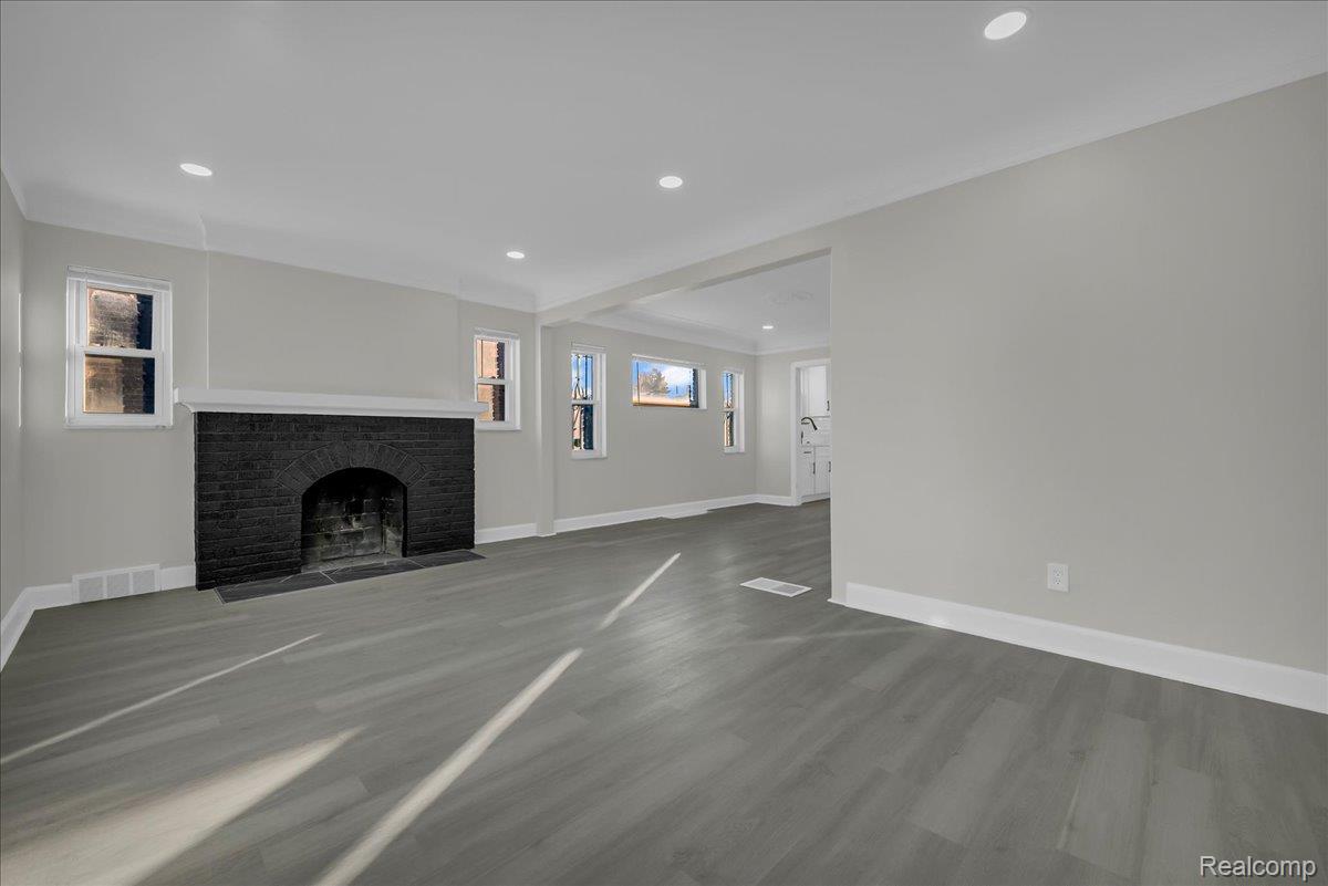 16717 Fielding Street Detroit, MI 48219 - Photo 6 of 46 Unfurnished living room with a brick fireplace, recessed lighting, and wood finished floors