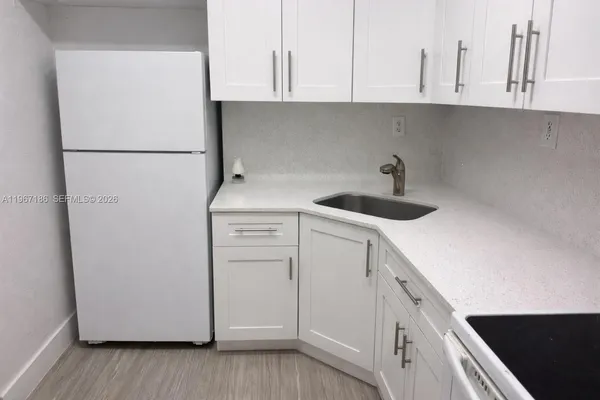 a kitchen with a sink and a refrigerator