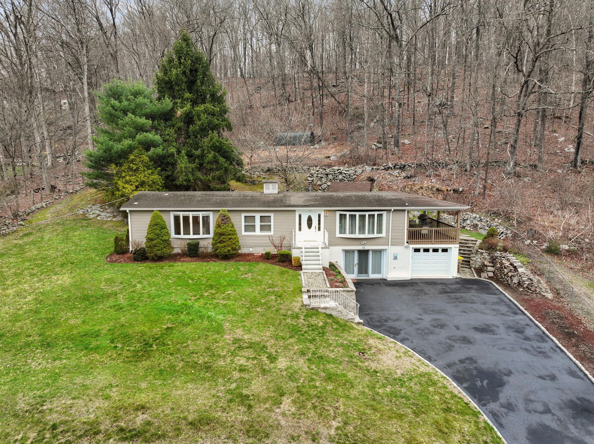 971 Peekskill Hollow Road Putnam Valley, NY 10579 - Photo 1 of 1 Ranch-style home featuring a front lawn, driveway, stairs, and a garage