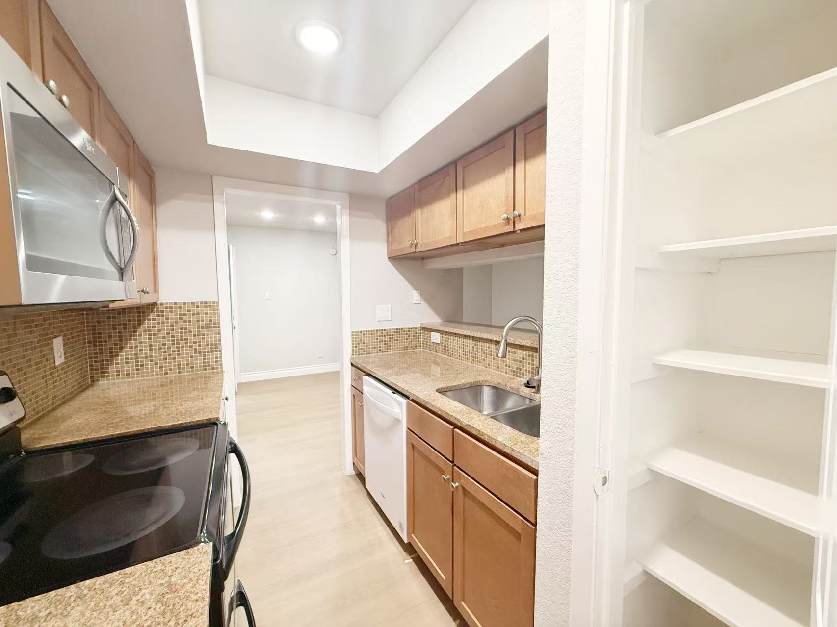 3204 Menchaca Road, Unit 601 Austin, TX 78704 - Photo 4 of 12 a kitchen with stainless steel appliances granite countertop a stove and a refrigerator