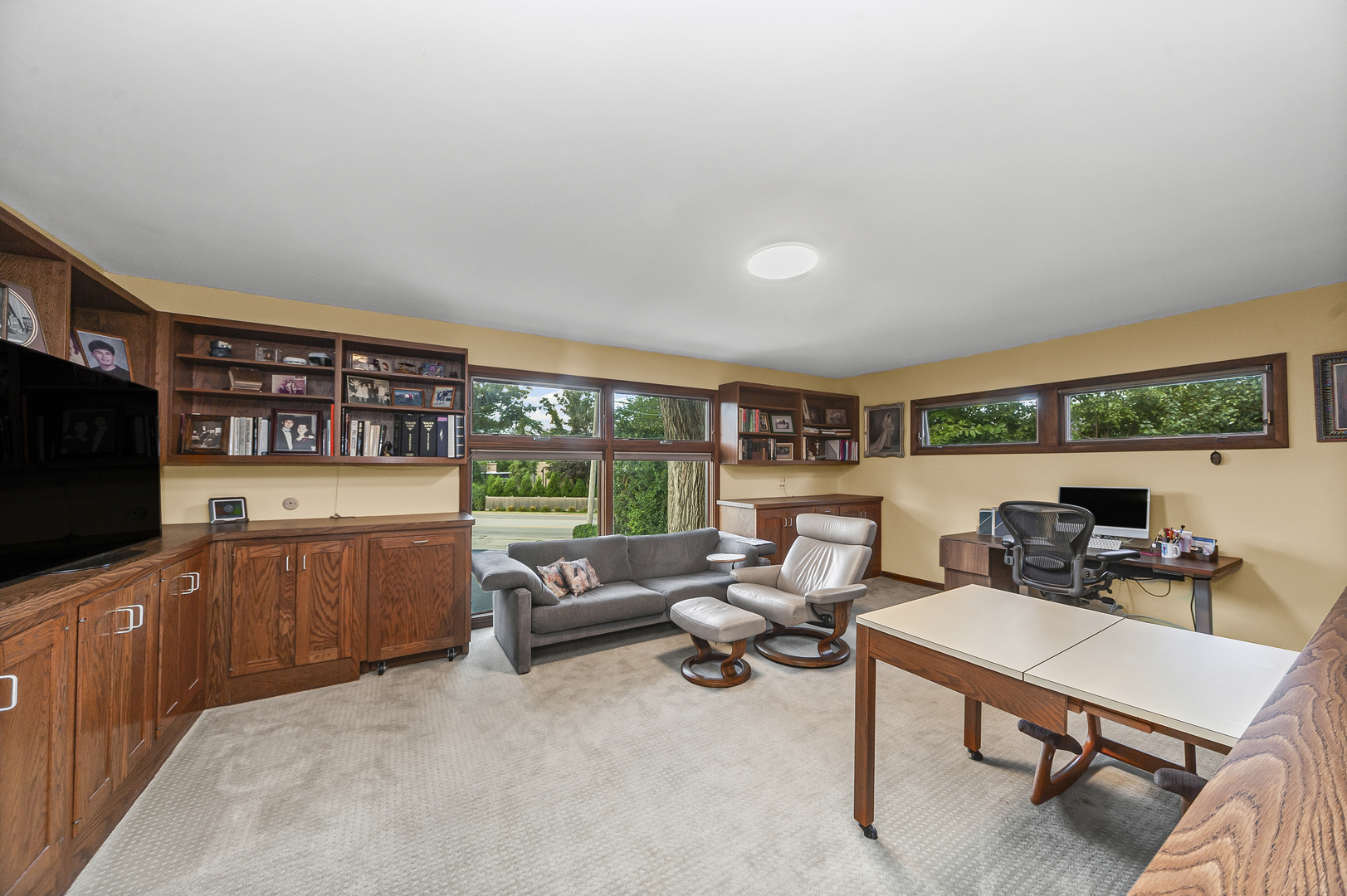 1128 Green Bay Road Glencoe, IL 60022 - Photo 13 of 28 a living room with furniture a flat screen tv and a floor to ceiling window