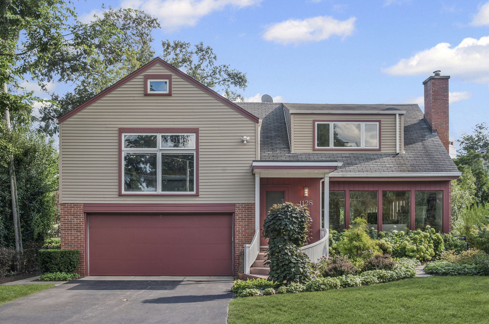 1128 Green Bay Road Glencoe, IL 60022 - Photo 2 of 28 a front view of a house with a yard and potted plants