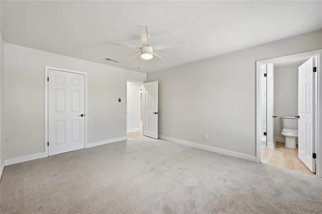 a view of an empty room with a bathroom