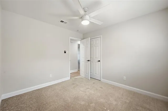 an empty room with a ceiling fan and a ceiling fan