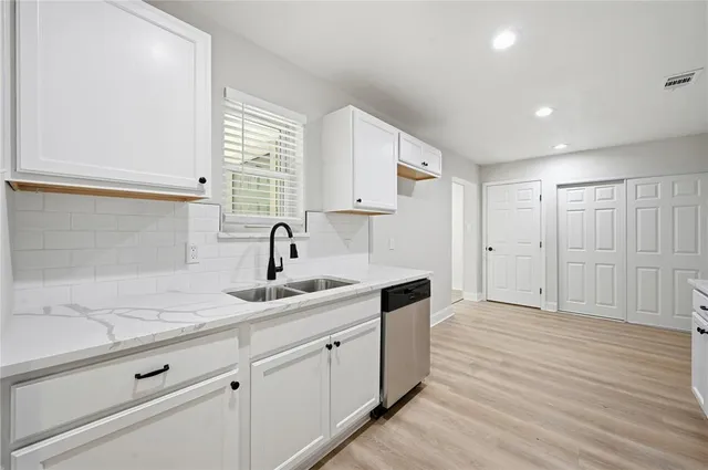 a kitchen with a sink and cabinets