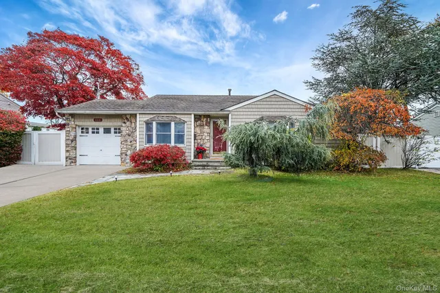 a front view of house with yard and green space